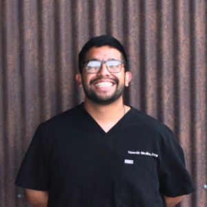 Dr. Medina smiling outside in black scrubs